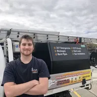 Plumber beside a service vehicle, Braeside
