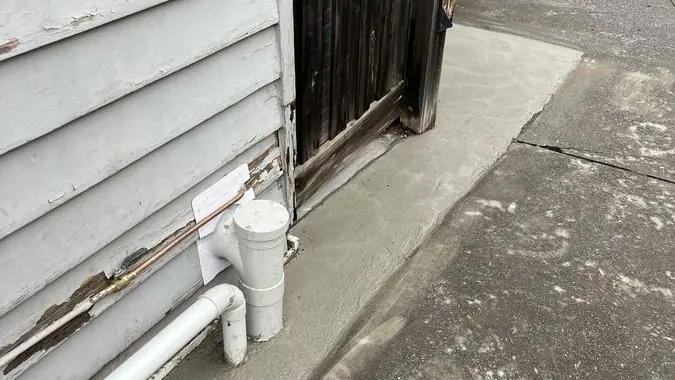 Outdoor pipework beside a house, Braeside